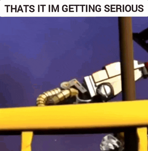 a robot is sitting on a yellow railing with the words `` that 's it im getting serious '' written on it .
