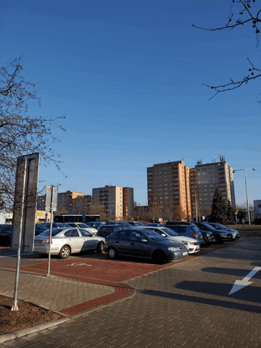 a lot of cars are parked in a parking lot with a sign that says no parking