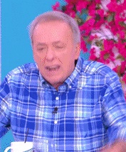 a man in a blue plaid shirt is holding a cup of coffee