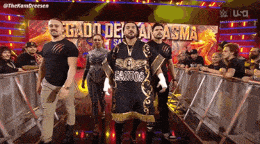 a group of people standing in front of a sign that says santo on it