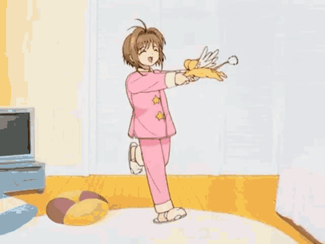 a girl in a pink pajama set is dancing in a living room while holding a pair of scissors .