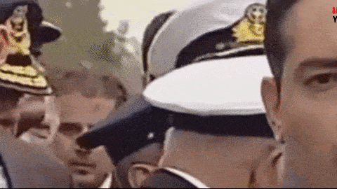 a group of men in military uniforms are standing next to each other in a crowd .