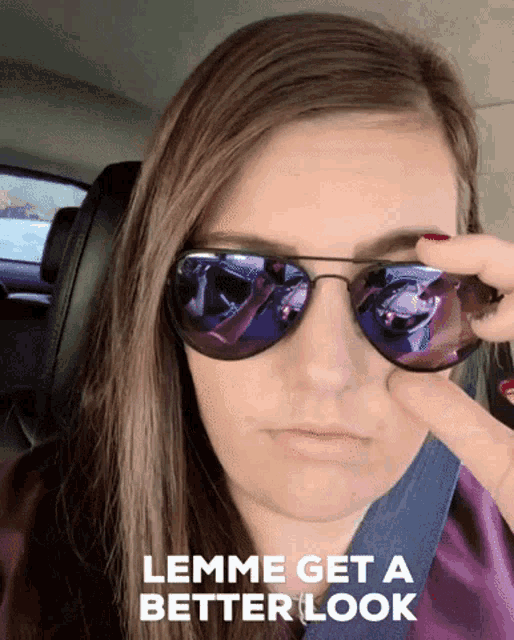 a woman wearing sunglasses with the words " lemme get a better look " below her