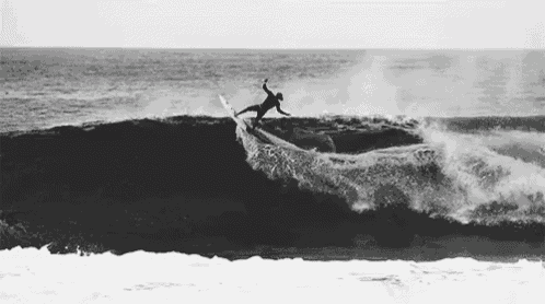 a surfer is riding a wave in the ocean .