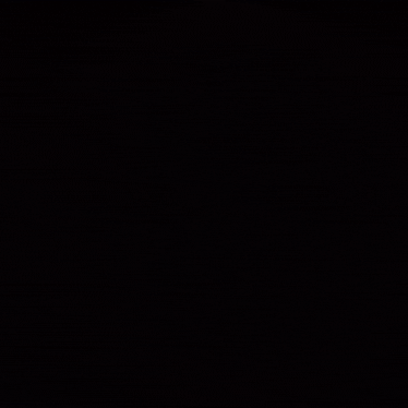 a blurred image of a car with a steering wheel in the background