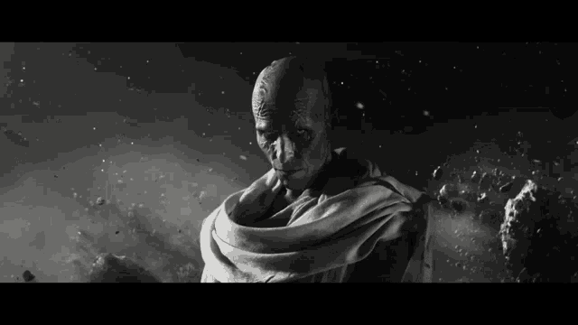 a black and white photo of a man with a scarf around his shoulders