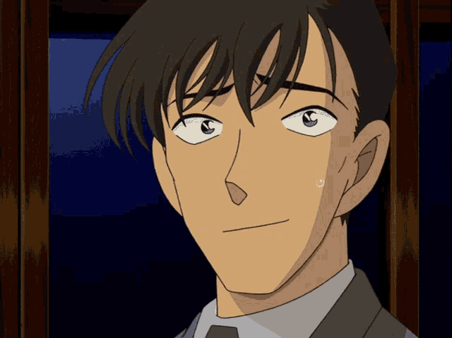 a close up of a man 's face with his eyes closed
