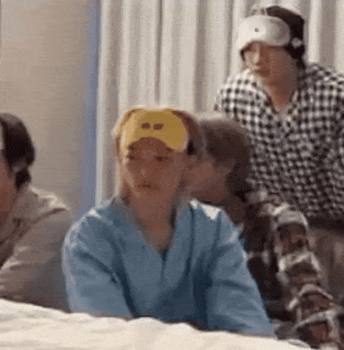 a group of people are sitting on a bed wearing sleep masks and sleeping glasses .