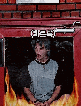 a man is sitting in a fire escape surrounded by fire .