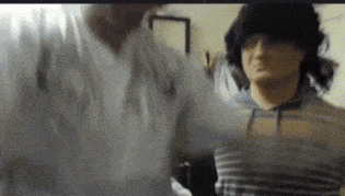 a blurry picture of two people standing next to each other in a room