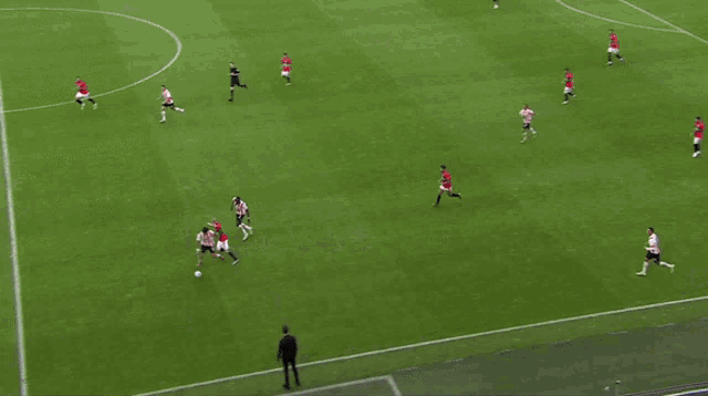 a soccer game is being played in a stadium sponsored by emirates