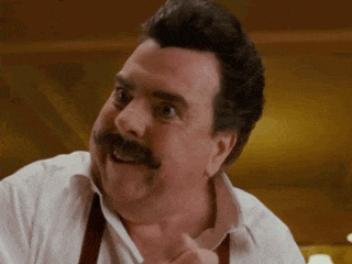 a man with a mustache is wearing a white shirt and brown suspenders