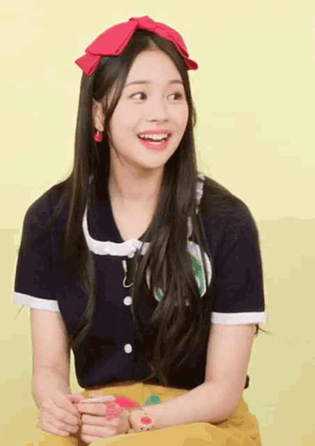 a girl wearing a blue shirt and a red headband