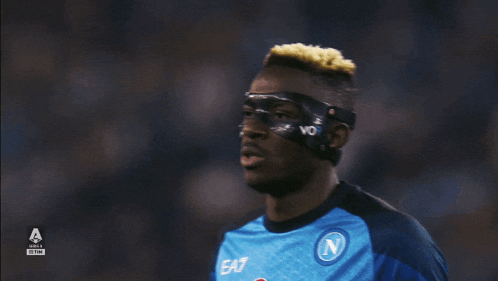 a soccer player wearing a mask with the letter n on his shirt