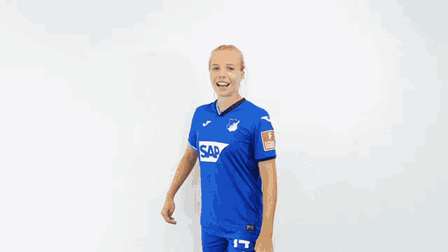a woman in a blue shirt that says sap on it