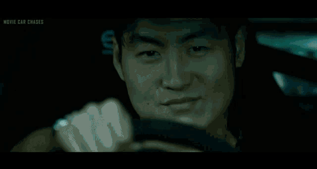 a blurred image of a man in a car with the words movie car chase written on the bottom right