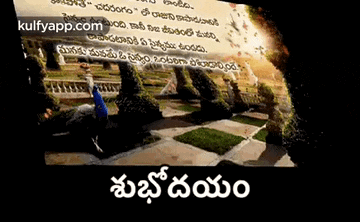 a man is doing a yoga pose in a park with a foreign language written on it .
