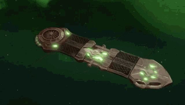 a person 's hand is glowing in a green light .