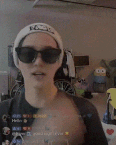 a man wearing sunglasses and a headband with the word hello on it