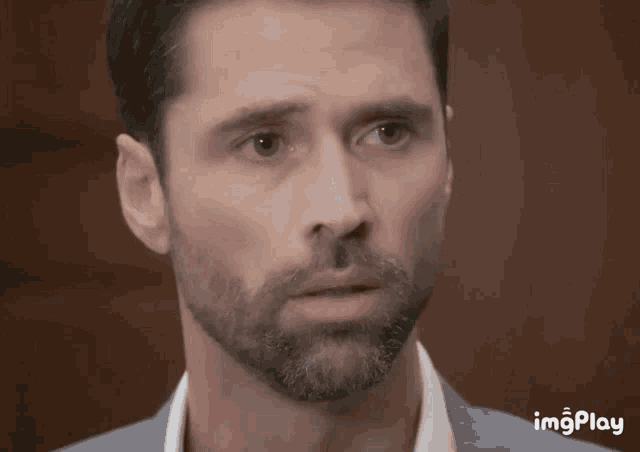 a close up of a man 's face with the words imgplay below