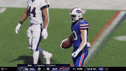a buffalo bills player is holding a football in his hand