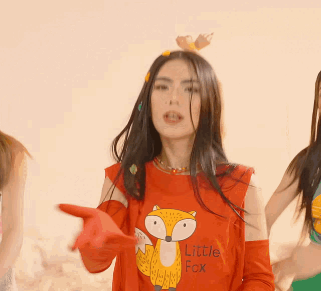 a woman wears a red shirt with a fox on it