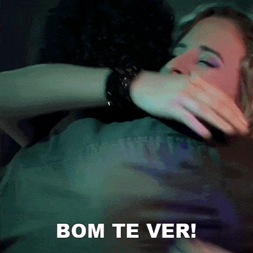a man and a woman hugging with the words bom te ver behind them