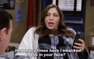 a woman is holding a cell phone and asking a man how many times have i smacked you in your face ?