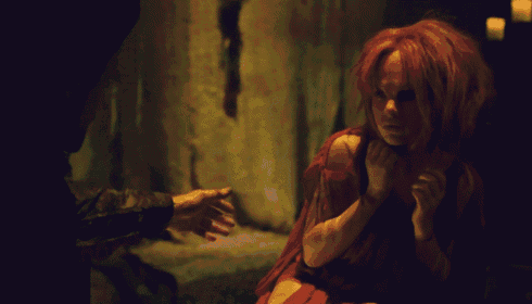 a woman with red hair is being held by someone