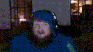 a man with a beard wearing a blue hoodie