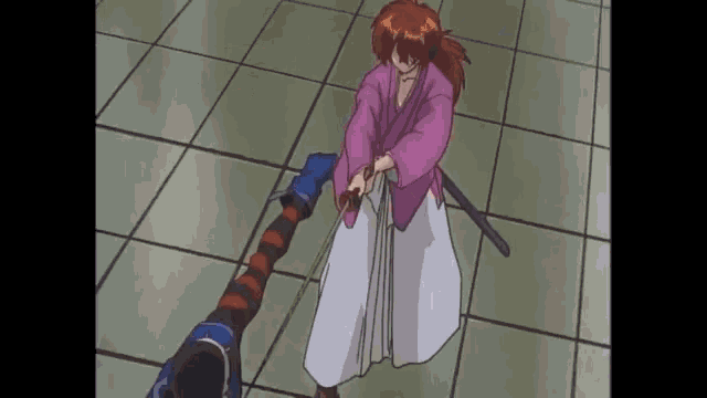 a man in a pink kimono is holding a sword in his hand
