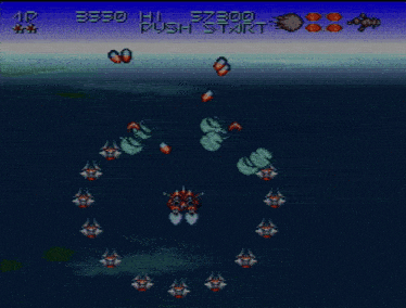 a video game screen shows a few ships in the ocean and says " push start "