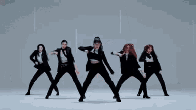 a group of women in suits and ties are dancing on a white background .