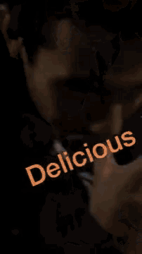 a close up of a man 's face with the words `` delicious '' written next to him .
