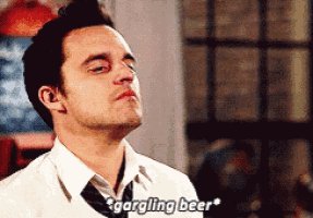 a man in a white shirt and tie is talking about gargling beer