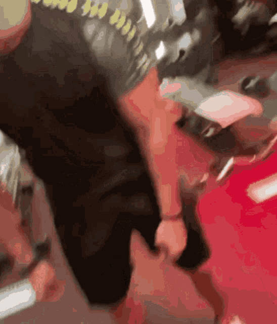 a blurred image of a person walking on a red carpet
