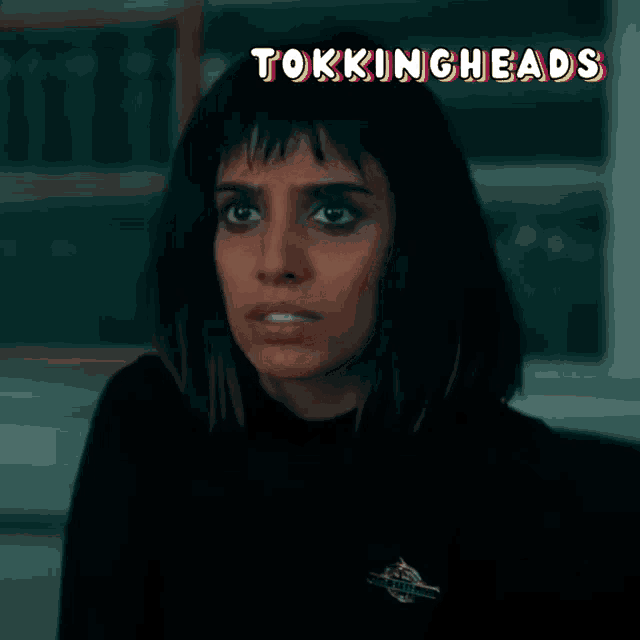 a close up of a woman 's face with the words tokingheads behind her