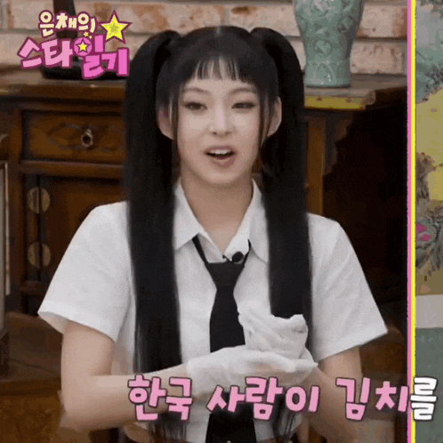a girl with pigtails is wearing a white shirt and a tie