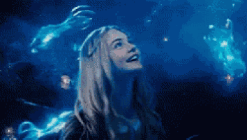 a woman is looking up at the sky in a dark room .