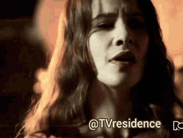 a close up of a woman 's face with the words @tvresidence written below her