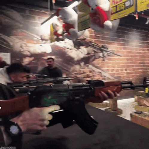a man is holding a gun in front of a sign that says 50 lots