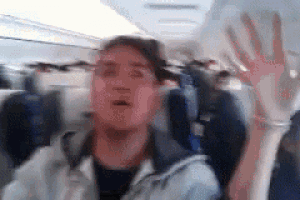 a blurry picture of a person sitting on an airplane .