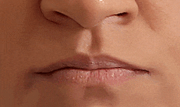 a close up of a woman 's face with a nose and lips