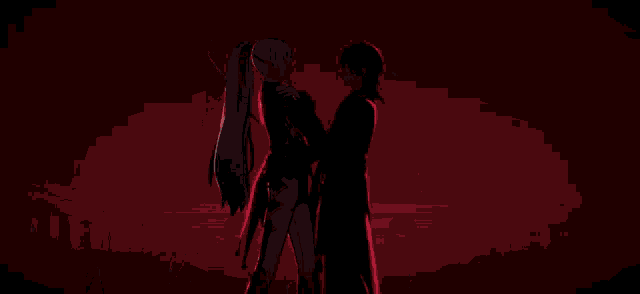 a man and a woman are standing next to each other in front of a red heart .