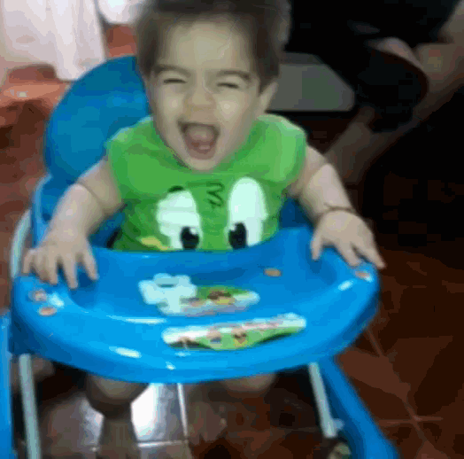 a baby in a blue high chair with a green shirt that says ny on it
