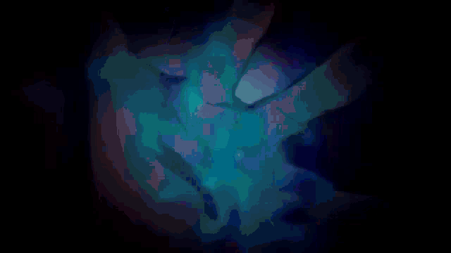 a blue and purple background with a hand holding a blue object