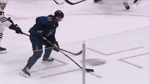 a hockey game is being played and the goalie is wearing the number 28