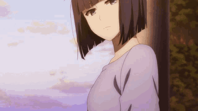 a girl with short hair leaning against a pole