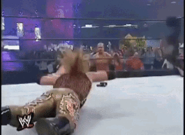 a wrestling match with a w logo on the ring