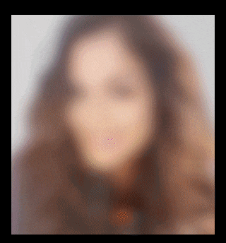 a blurry picture of a woman 's face with long hair
